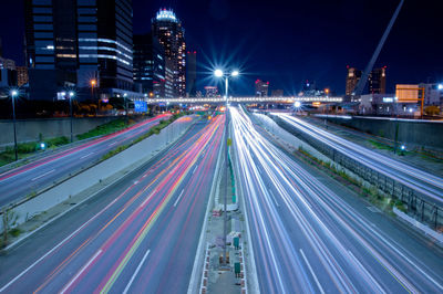 High angle view of light trails on road at night