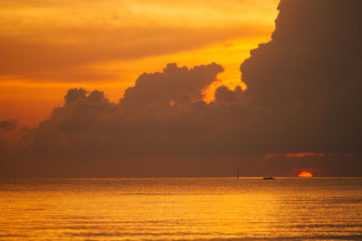 Scenic view of sea against orange sky