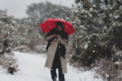 Reflection of person in snow on tree