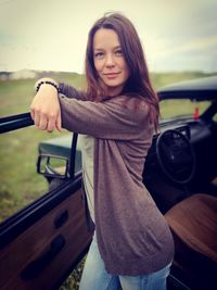 Portrait of smiling young woman in car