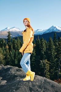 Portrait of young woman standing on mountain