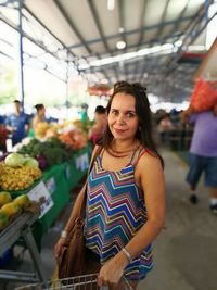 Portrait of smiling young woman in market