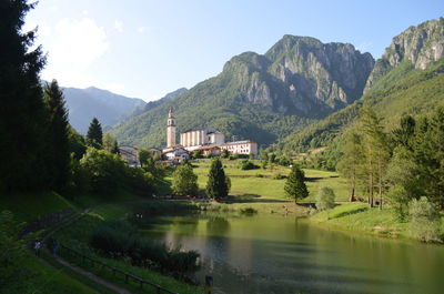 Scenic view of lake by mountains against sky