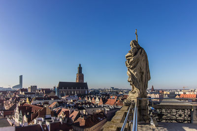 Statue of buildings against clear blue sky