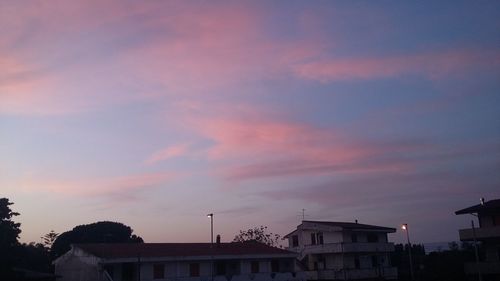 Low angle view of buildings against sky during sunset