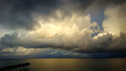 Scenic view of sea against storm clouds