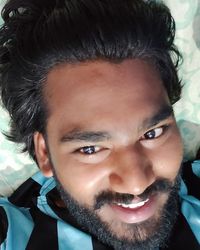 Close-up portrait of smiling young man