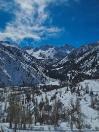 Scenic view of snow covered mountains against sky