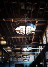 Low angle view of illuminated pendant lights hanging from ceiling