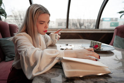 Woman sitting on table at restaurant