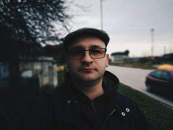 Portrait of young man wearing sunglasses standing outdoors