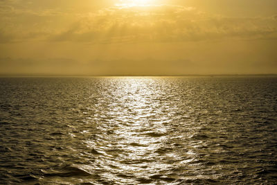 Golden sunset sun over sea. sun's rays break through clouds. magnificent seascape. copy space.