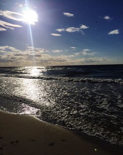 Scenic view of beach against sky during sunset