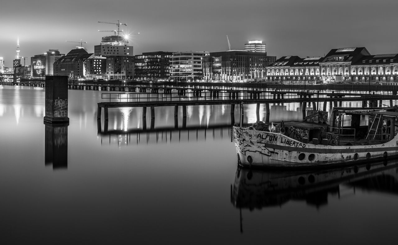 REFLECTION OF ILLUMINATED BUILDINGS IN RIVER