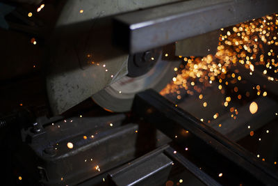 Sparks fly in all directions. cutting metal with a grinder. working in a metal workshop. 