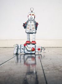 Red toy on table against wall