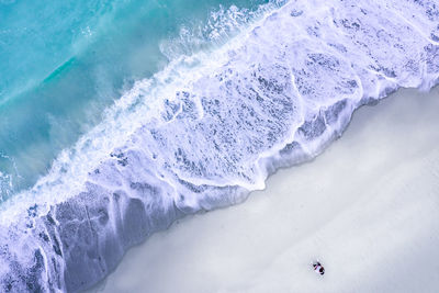 High angle view of people on snow in sea