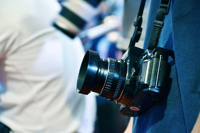 Close-up of man photographing camera