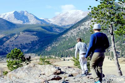 Rear view of people walking on mountain road