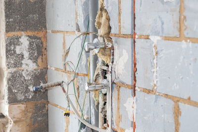 Close-up of damaged wall against building