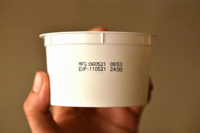 Close-up of hand holding coffee cup