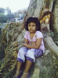 Portrait of girl sitting outdoors