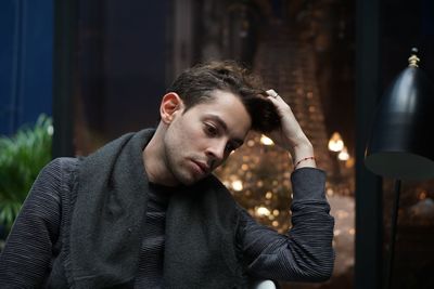 Portrait of young man looking away outdoors