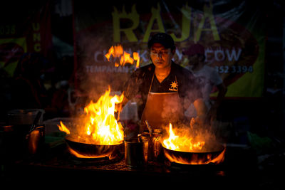 View of fire on barbecue at night