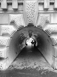 People walking in corridor of building