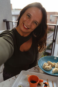 Portrait of young woman having food