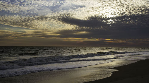 Scenic view of beach against sky during sunset