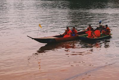 People sitting on boat in river