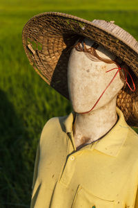 Close-up of person wearing hat on field