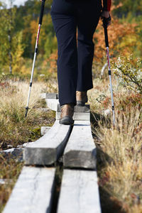 Hiker on wooden path, low section