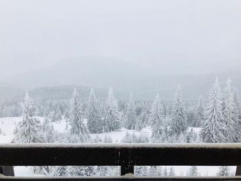 Frozen landscape against sky during winter