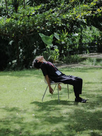 Side view of young woman exercising in park