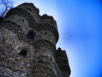 Low angle view of built structure against clear blue sky