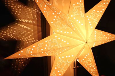 Low angle view of illuminated christmas lights at night