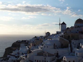 Townscape by sea against sky
