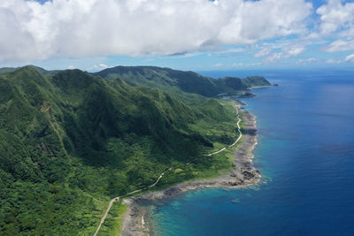 Scenic view of sea and mountains against sky