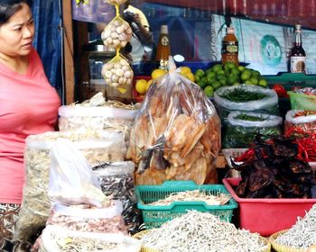 Man for sale at market stall