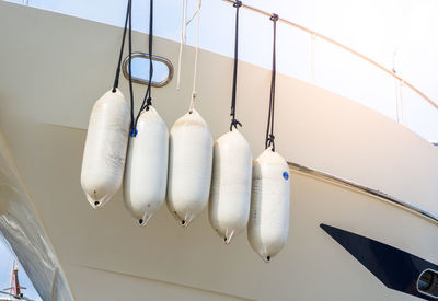 Low angle view of clothes hanging against white wall