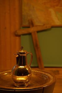 Close-up of wineglass on table against wall