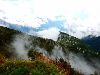 Scenic view of mountains against cloudy sky at darjeeling