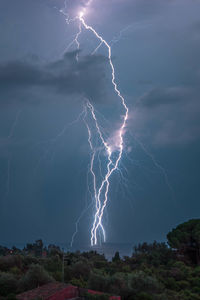 Low angle view of lightning against sky at night