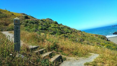 Scenic view of land against clear blue sky