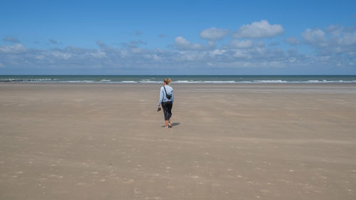 Full length of man on beach against sky