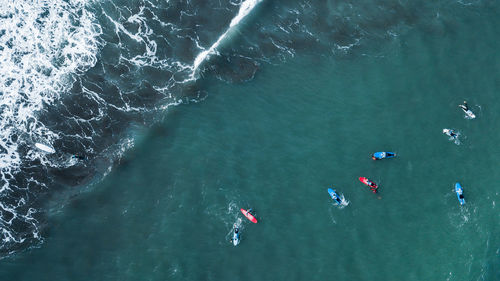 Group of surfers waiting to surf a wave