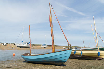 Boats moored on sea against sky