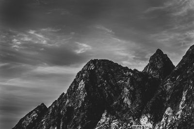 Low angle view of rocky mountains against sky